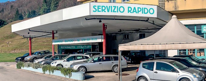 Insegna turchese e piazzale dell’officina Servizio Rapido Riparauto ad Agno